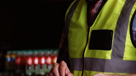 Male-worker-using-digital-tablet-in-warehouse