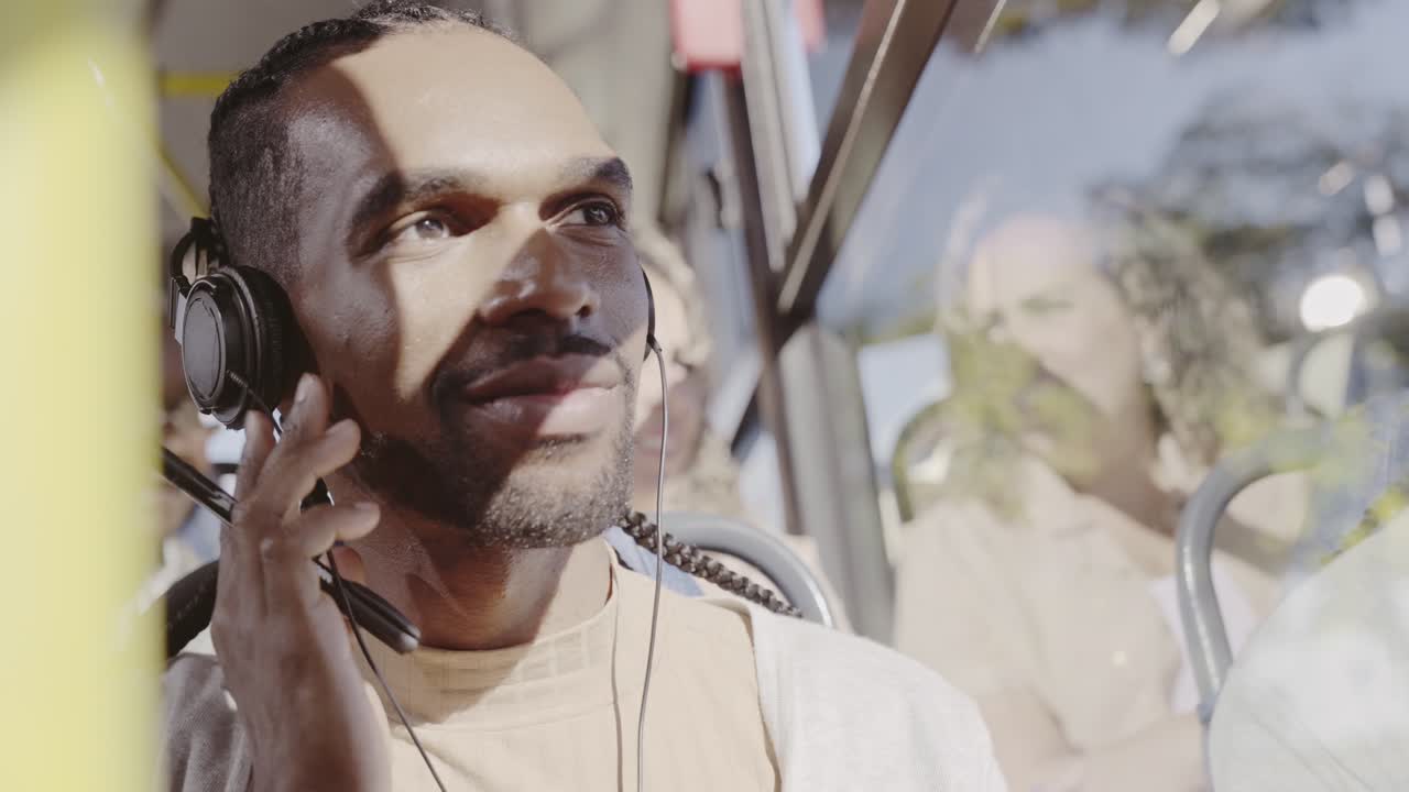 Man with headphones traveling on a bus