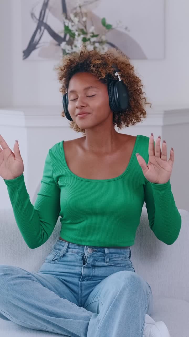 Enjoying music with headphones and a peaceful smile in a cozy space