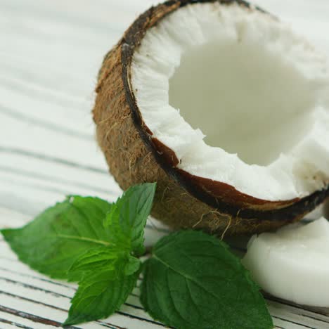 Halves-of-fresh-coconut-with-mint-leaves