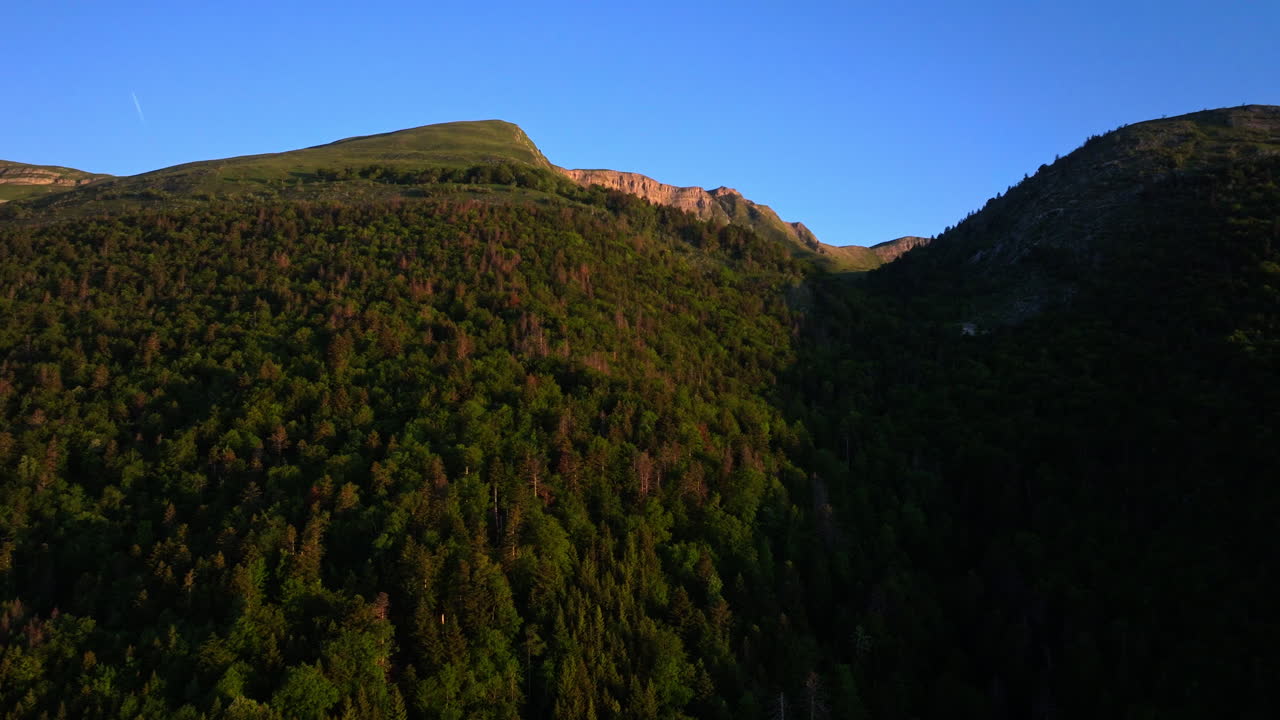 Aerial sunrise over Lake Geneva with fiery orange and red skies, panoramic Alpine views, and tranquil morning reflections on Lac Léman from the Jura.