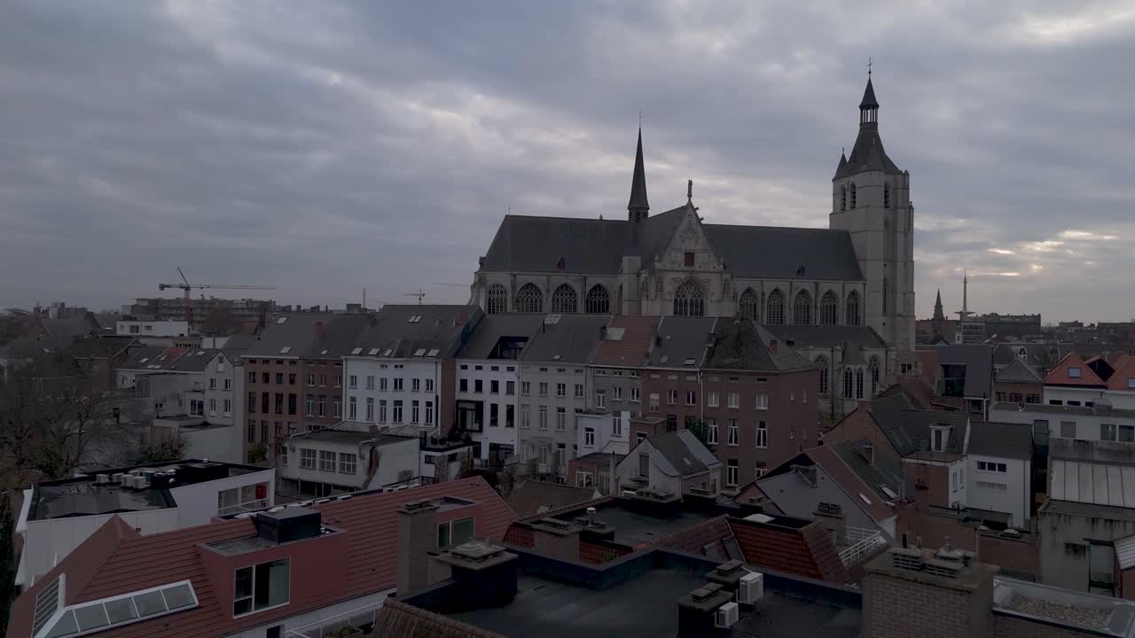 Drone shot of a medieval church in the city center surrounded by houses