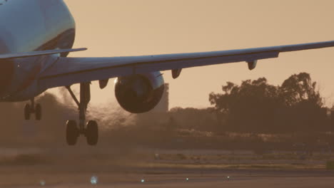 airplane landing at sunset