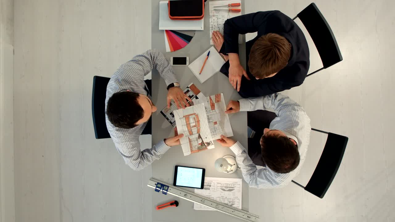 Top view of Colleagues interior designers discussing data with blank screen new modern computer laptop and pro digital tablet with sample material