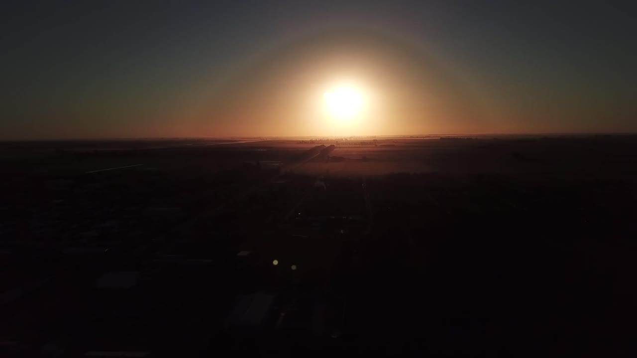 Drone Aerial view of the exact sunset moment in a country town