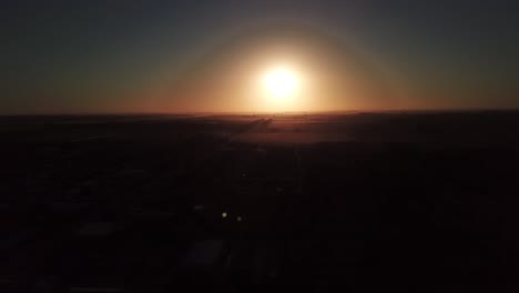 drone aerial view of the exact sunset moment in a country town
