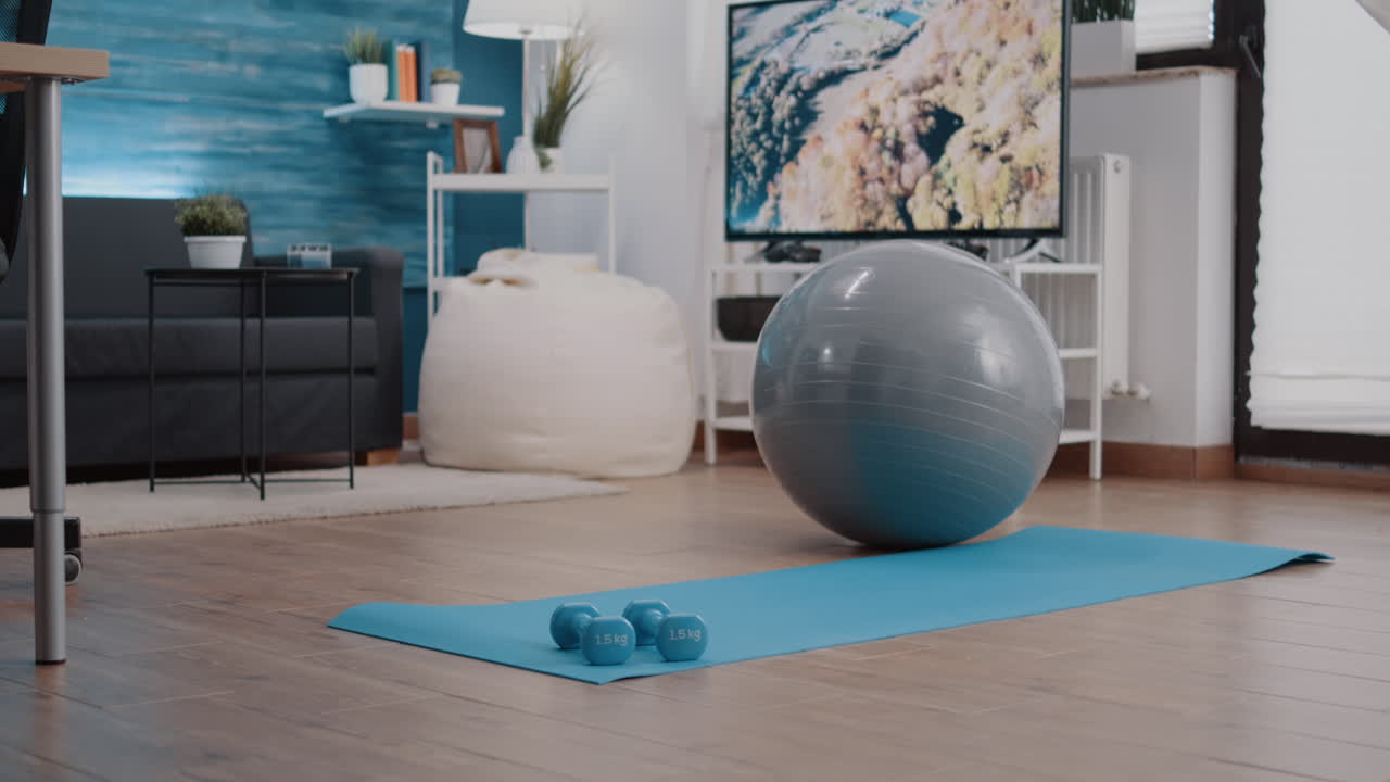 Nobody in living room with sport equipment on floor