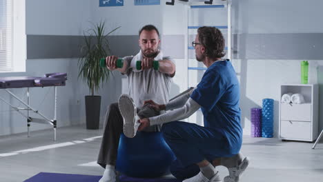 physical therapy session with dumbbells and exercise ball