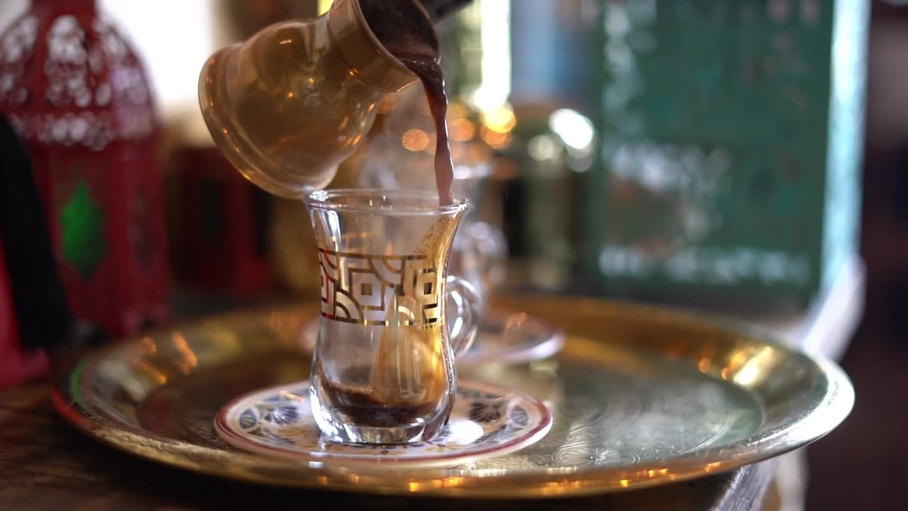 A man pours coffee on a cup, close up shot, insert shot