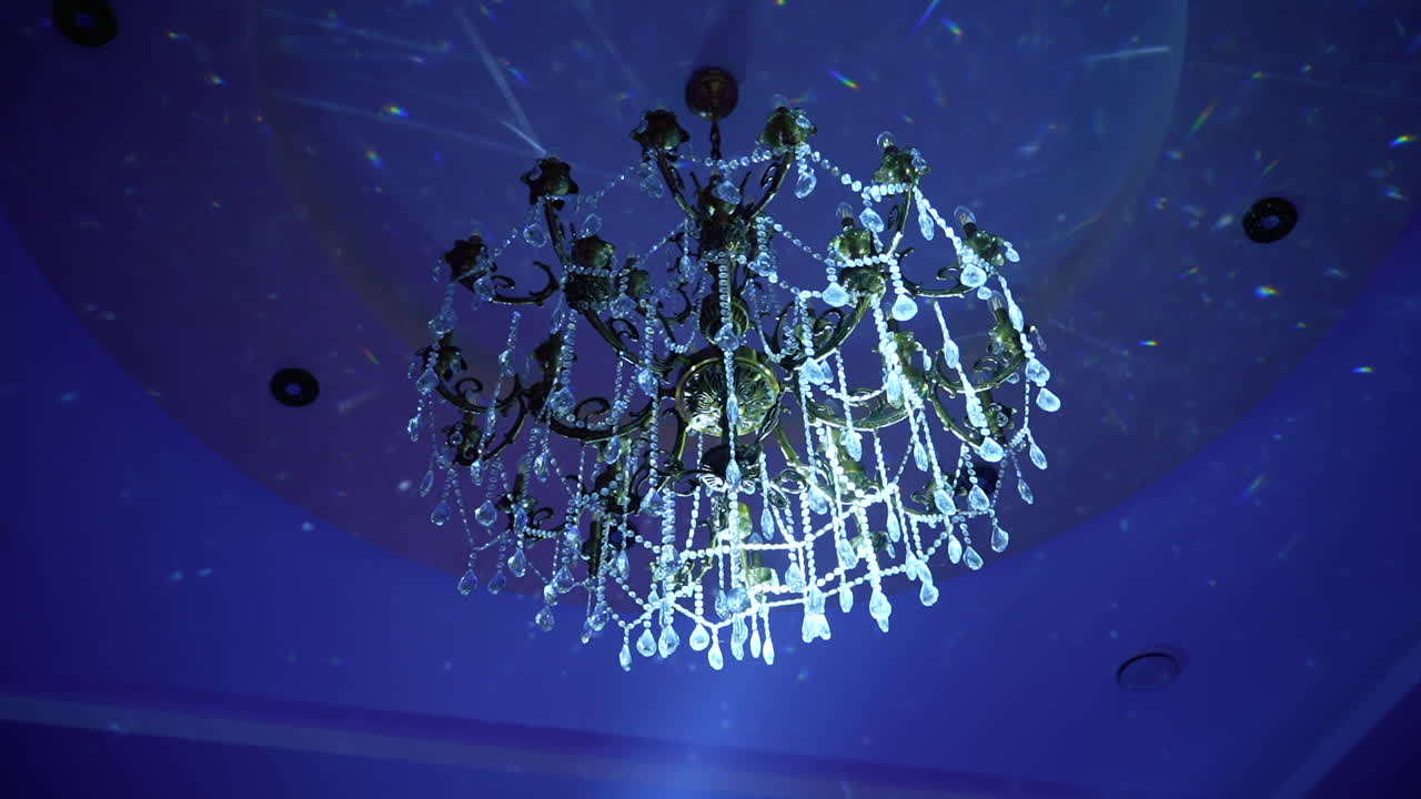 Modern glass chandelier. Luxury expensive chandelier hanging under ceiling