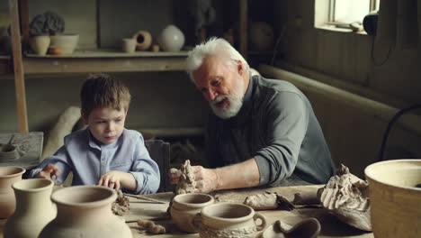 grandfather and grandson creating pottery