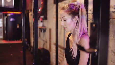 Handheld-Shot-Of-Young-Woman-Looking-Down-And-Contemplating-At-Health-Club