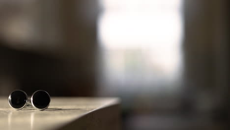 close-up of elegant cufflinks on marble surface