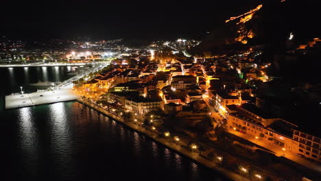 Flying-over-Nafplio,-Greece-at-night