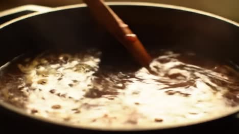 a step-by-step guide to perfecting your culinary skills: a close-up on the art of stirring a rich sauce in a pan for flavor infusion and texture development