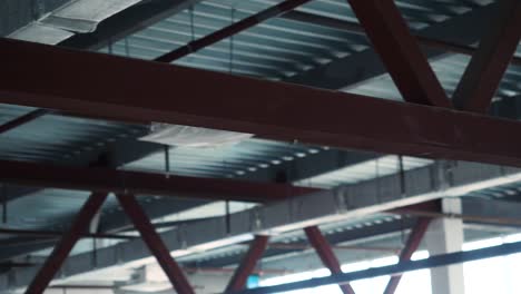 interior construction of building showing metal beams and trusses