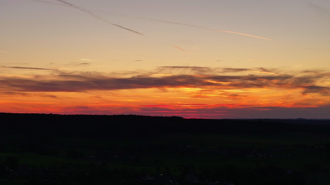 Darkness of the night prevails Dutch landscape below at sunset, aerial