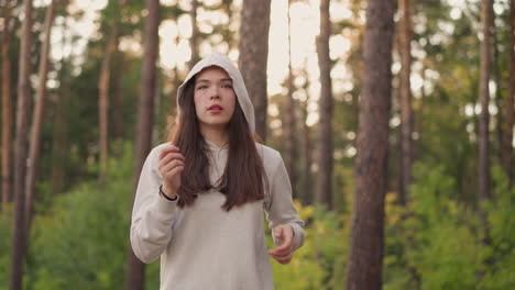 young woman walking through the forest