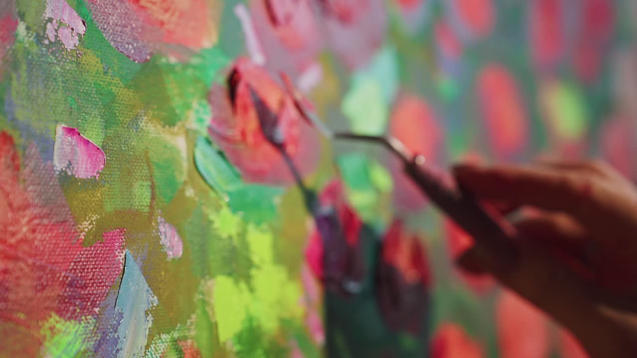 Artista che mescola e applica pittura colorata su tela