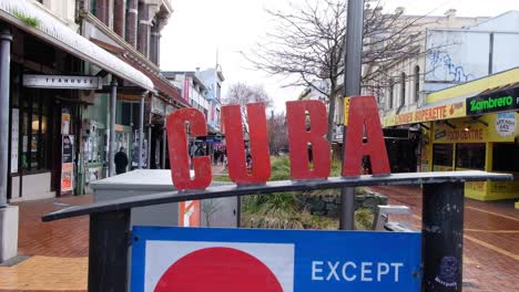 cuba street sign and shops in wellington, new zealand