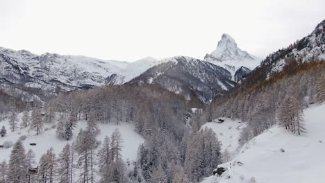 The-Matterhorn-aerial-cinematic-drone-stunning-wintery-opening-scene-Zermatt-Switzerlands-Swiss-Alps-most-famous-mountain-peak-early-October-heavy-fresh-snowfall-down-jib-movement