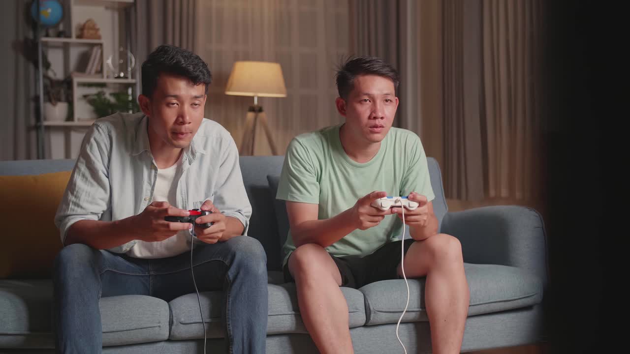 Asian Friends Playing Video Games At Home.