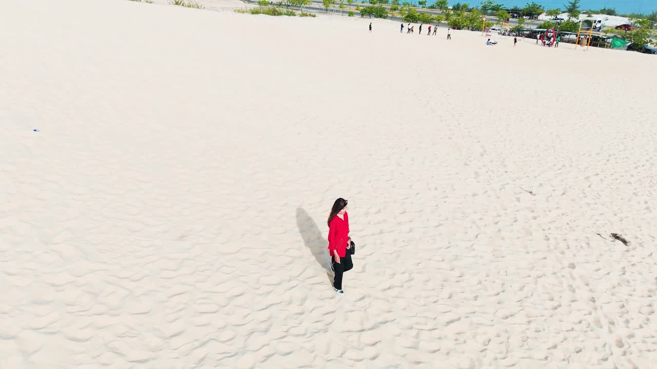 Aerial View Orbit of a Girl Walking in the Desert in Vietnam.
