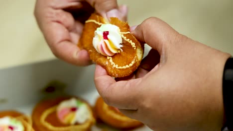 hands breaking and sharing a cupcake