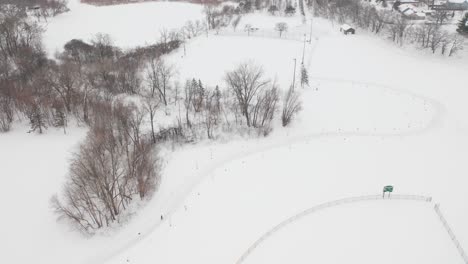 aerial, snow covered small town in america during winter