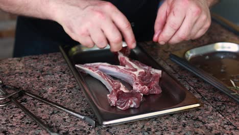 chef preparing raw lamb ribs