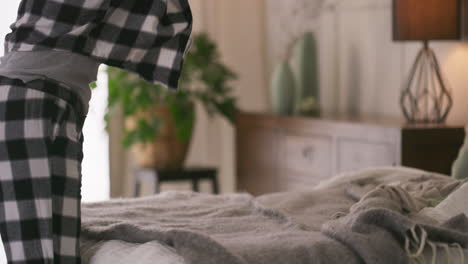 a person folding laundry in a bedroom