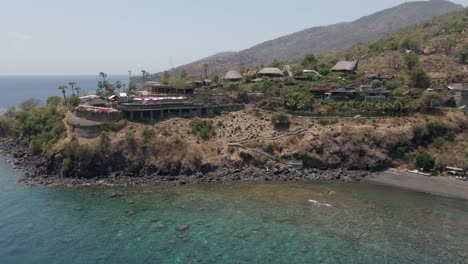 sunset point amed bali restaurant on promontory over rocky beach