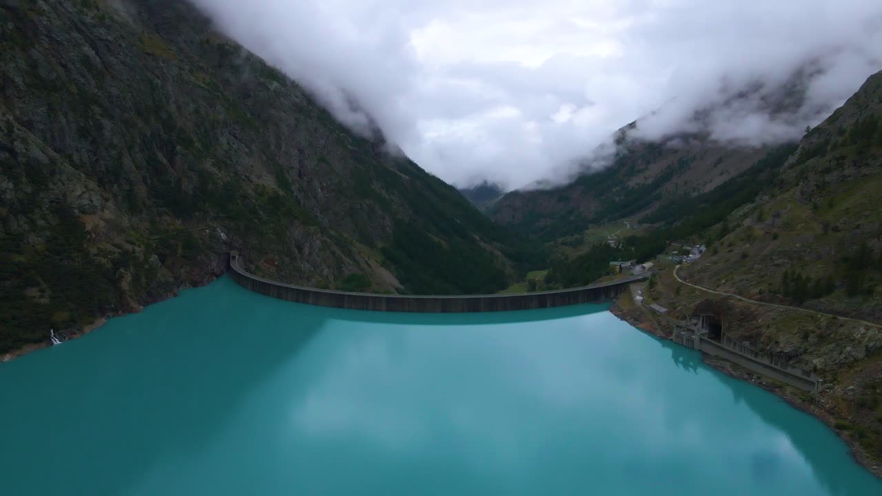 Drone shot flying sideways over the Place Moulin dam in the province of Aosta in Italy