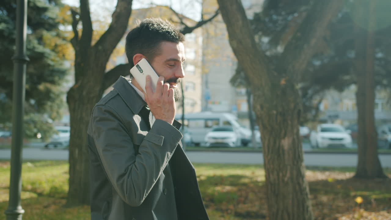 Businessman Talking on Phone in the Park