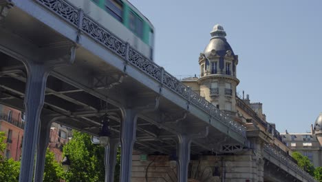 Subway-Metro-Train-Passing-On-Upper-Level-Of-Pont-de-Bir-Hakeim-Spanning-Seine-River-In-Paris,-France