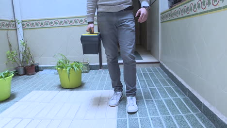 man carrying a toolbox in a hallway