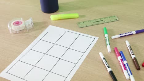 person drawing and measuring on grid paper