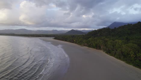 Clouded-Sky-Over-Sandy-Beach-With-Daintree-Tropical-Forest-In-North-Queensland,-Australia