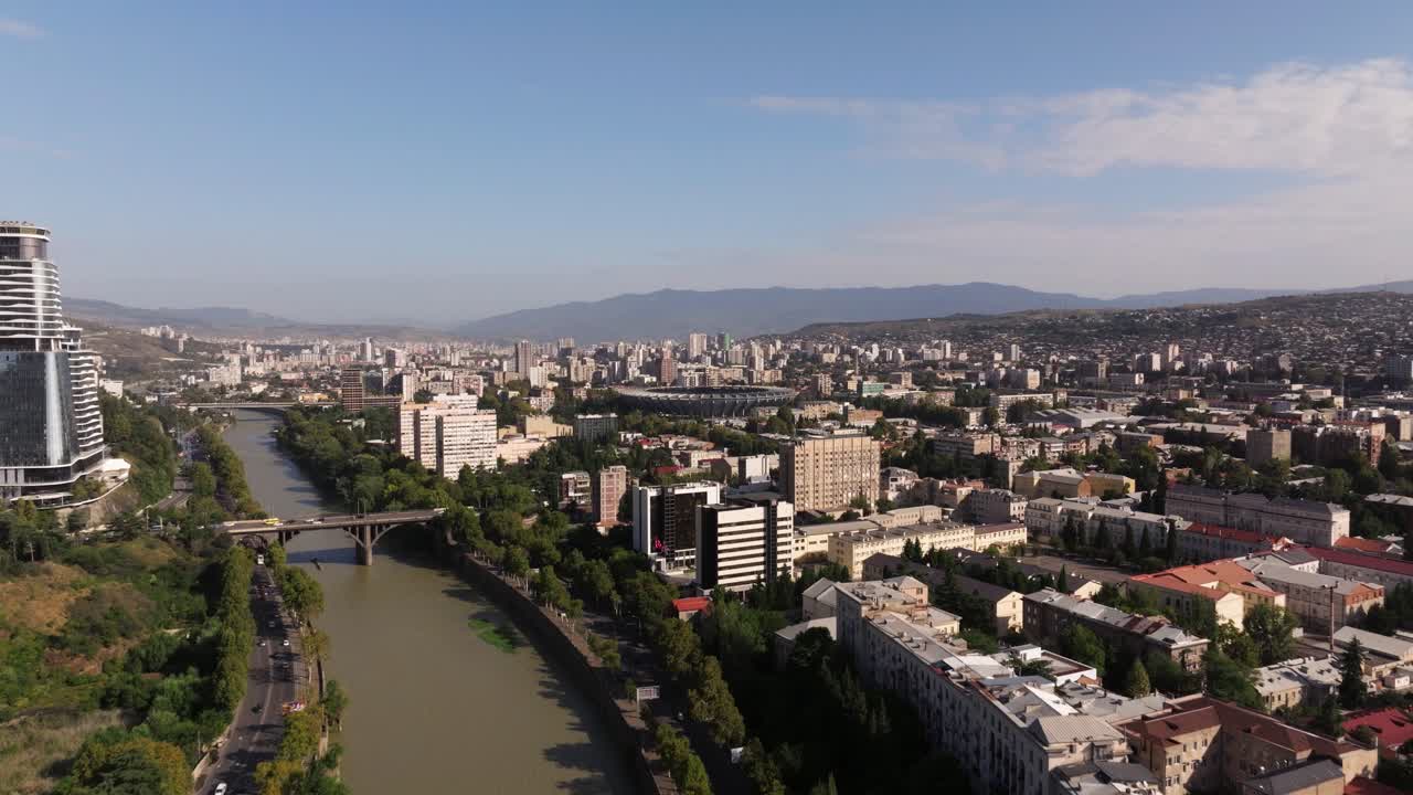 Přední záběr dronem nad řekou Kura v centru Tbilisi za horkého letního dne