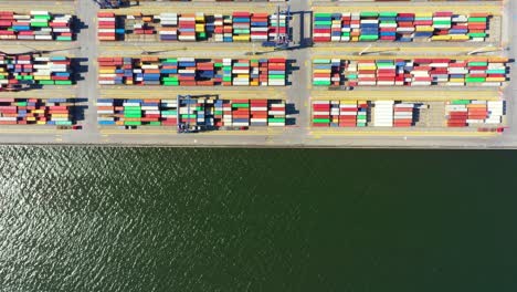 Container-ship-in-import-export-and-business-logistic,-By-crane,-Trade-Port,-Shipping-cargo-to-harbor,-International-transportation,-Business-logistics-concept,-Aerial-view