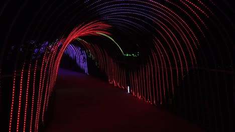 led lighting festival in the park walking through led tunnel – slow mo