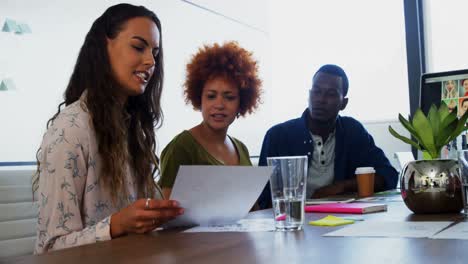 Team-of-executives-discussing-over-document-in-the-meeting