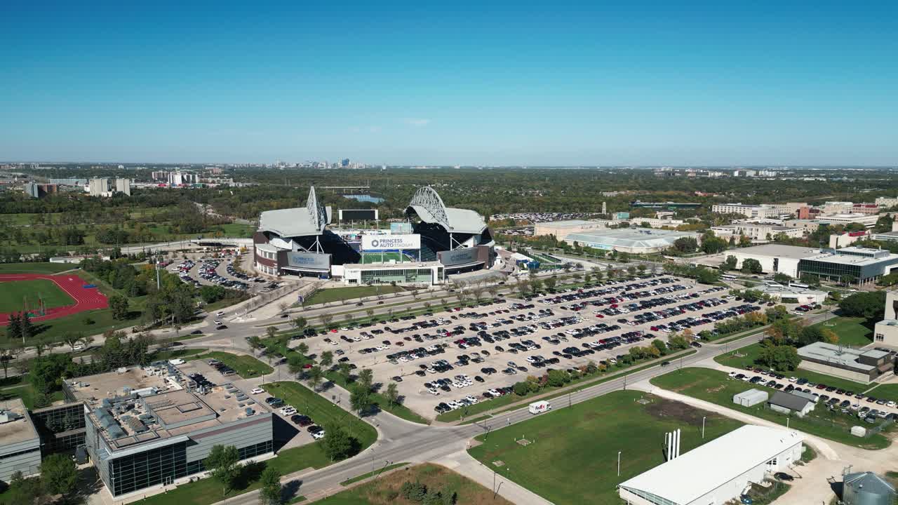 Drone captures Princess Auto Stadium and UM campus with Winnipeg skyline in autumn
