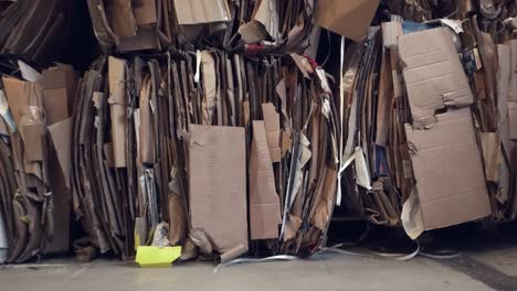 moving clip of a waste paper waiting to be recycled in the warehouse