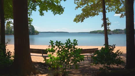 Camera-Pedestal-Up-to-Reveal-Benches-on-Shore-of-Lake-Norman,-North-Carolina