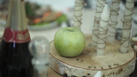 table setting with green apple and candles