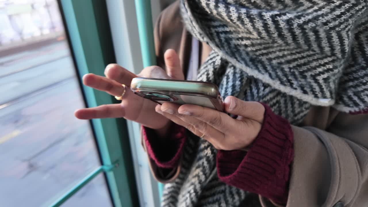 Close-up of Person's Hands Using Smartphone on Public Transport