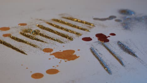 Addict-Concept-Glitter-Lines-with-Gold,-Silver,-and-copper-Paint-Drippings