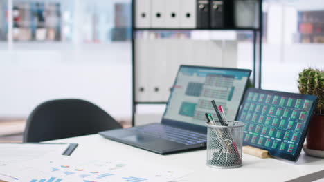 Laptop-device-on-office-desk-in-empty-workspace-showing-volatile-stock-exchange