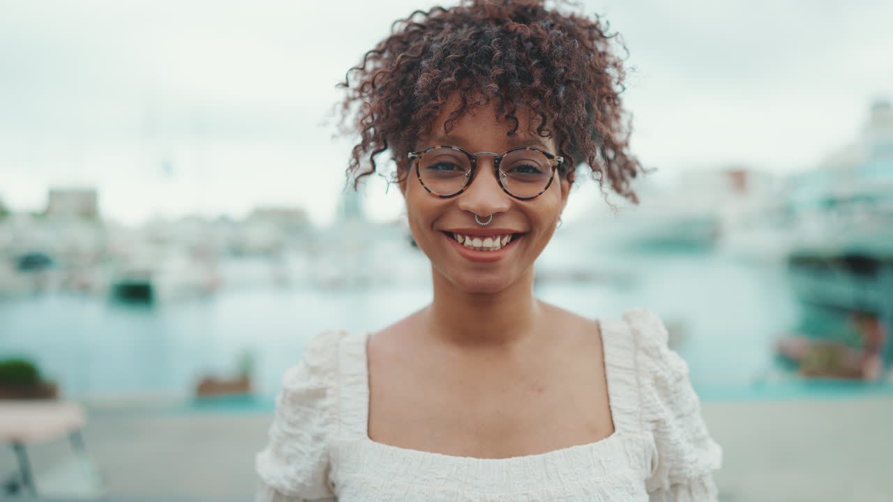 Smiling woman with glasses in an urban setting